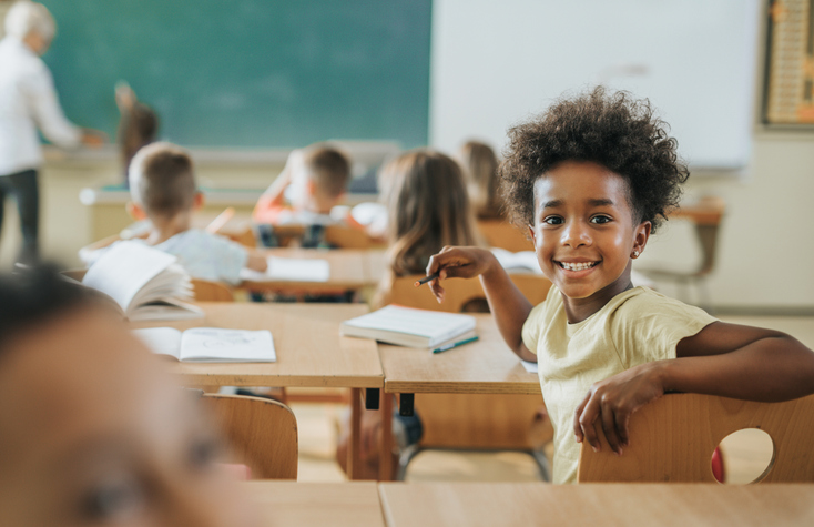 happy young student smiling in his classroom