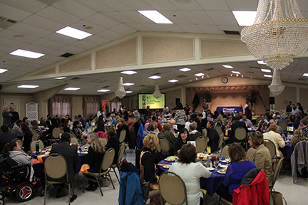 Big room full of tables of people