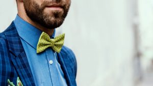 Man wearing a blue suit and green bow tie