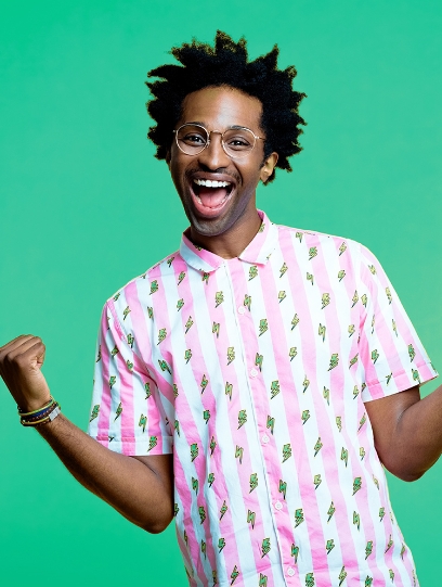 Man standing wearing a pink and white striped shirt