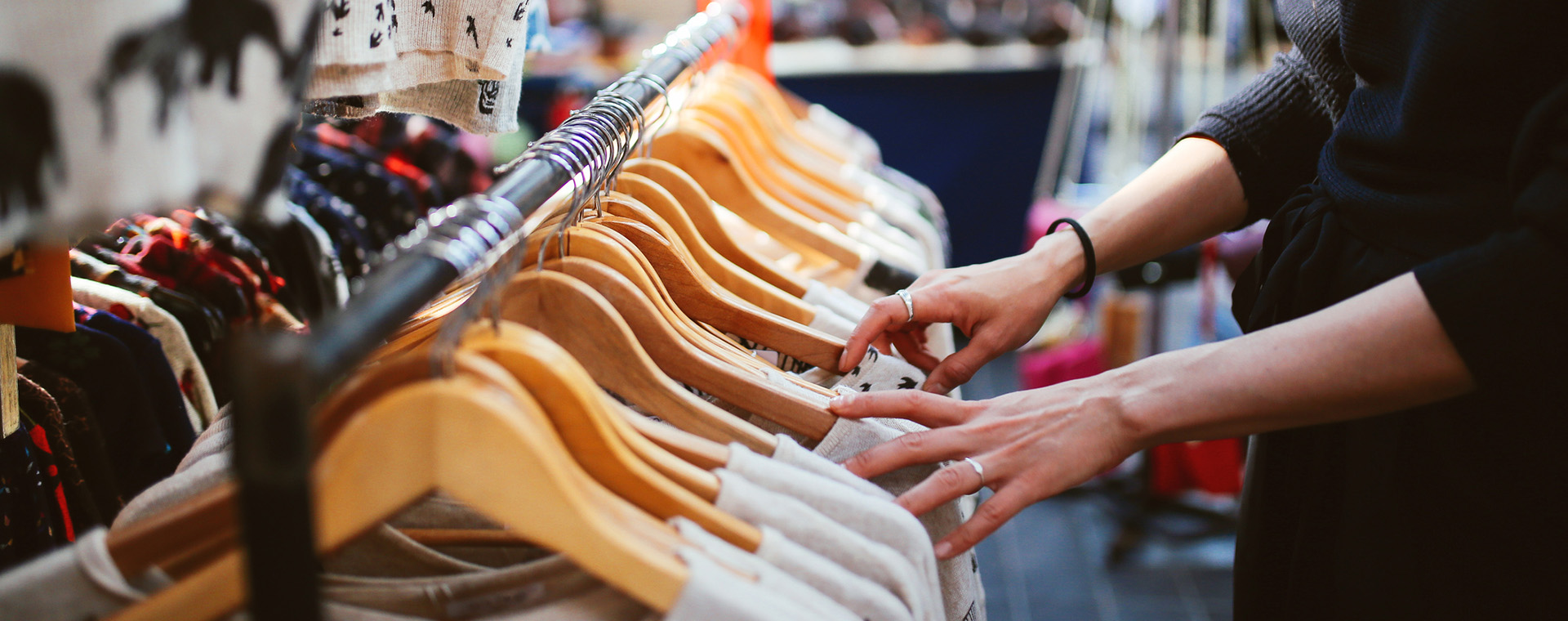 Someone looking at racks of clothes on the computer