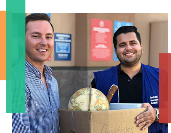 Two men holding a box or donations