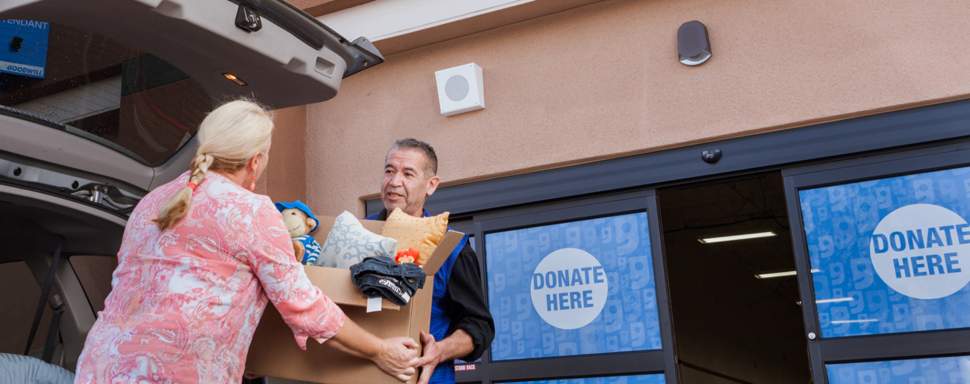 Older women handing a box to an employee