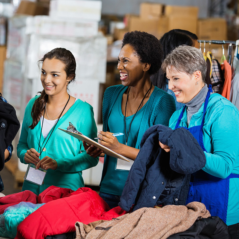 three women smiling on a wearhouse