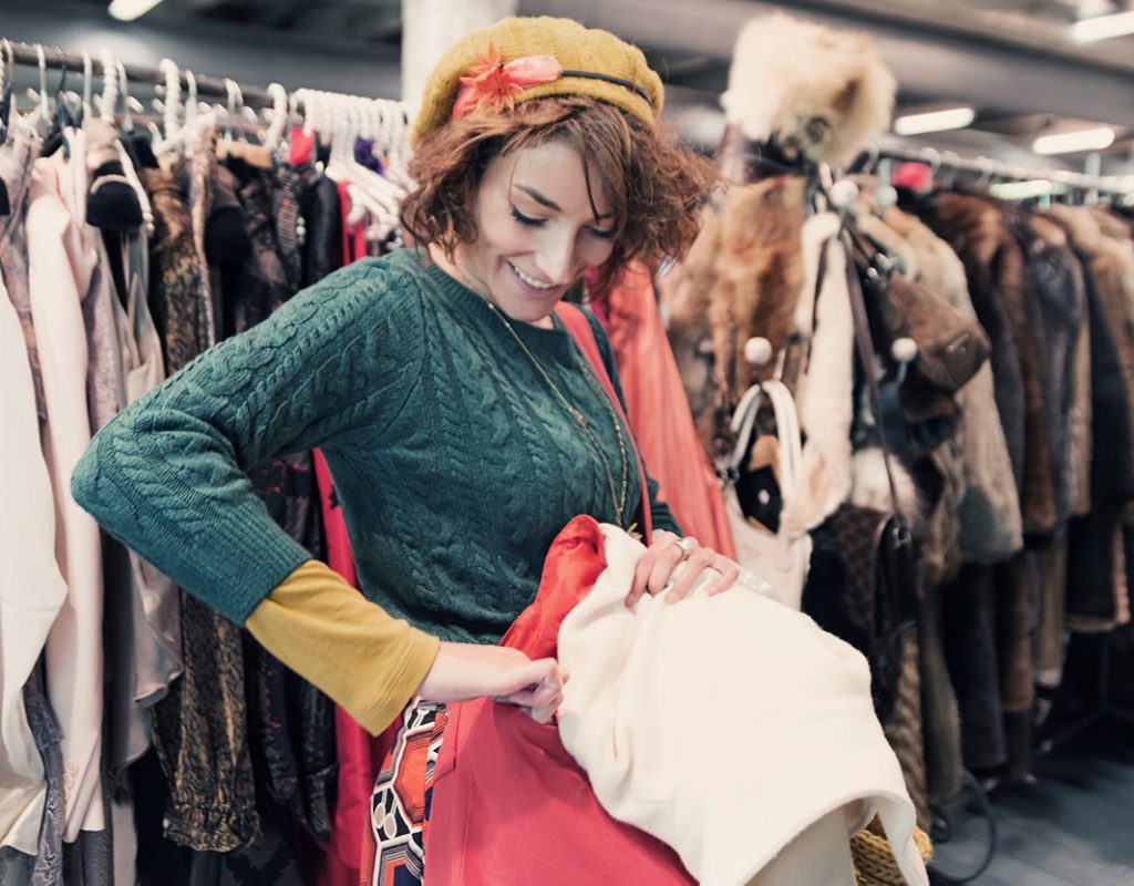 Women shopping through racks of coats