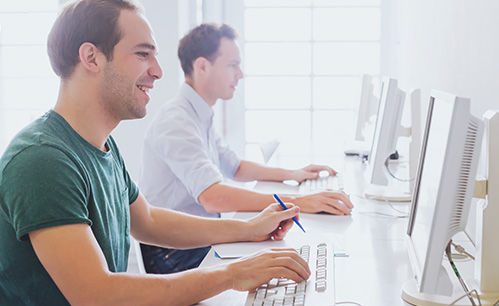 Two guys on the computer working