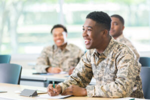 Military man sitting in a classroom smiling