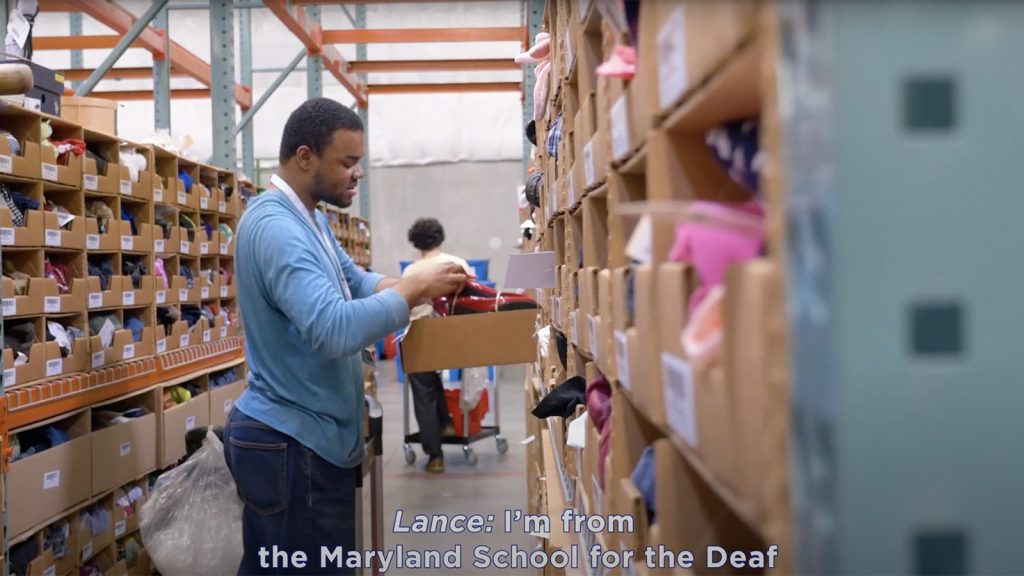 Guy looking through shelves in a warehouse