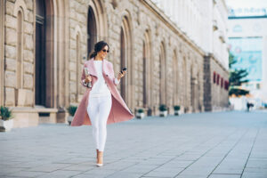 woman walking in a street wearing business casual outfit