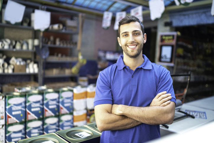 Portrait of a young sales man standing in a paint store | entry level job positions