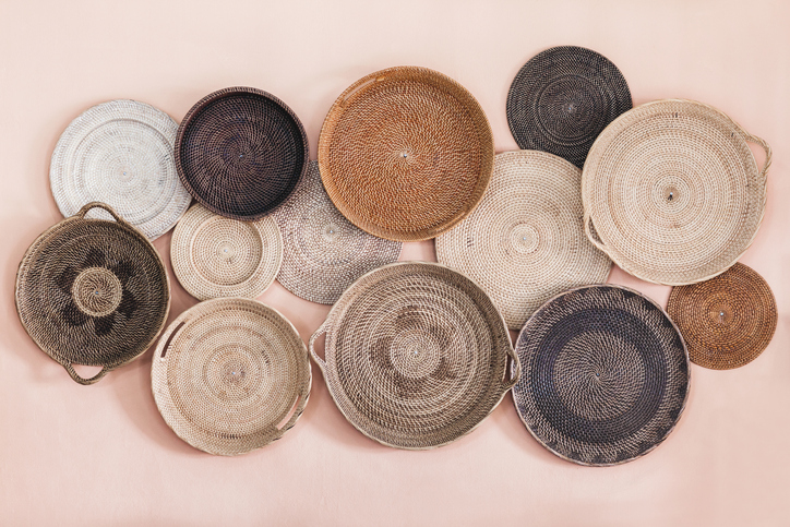 Wall decorated with different wicker handmade trays and baskets. Eco style and concept, Moroccan culture.