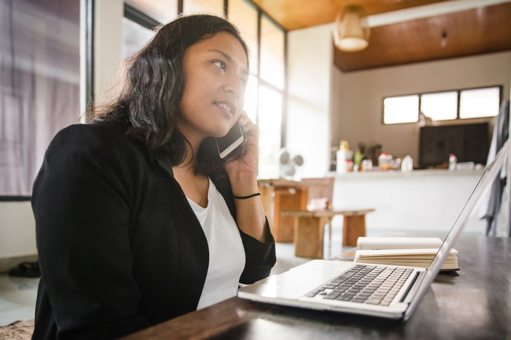 A shot of a young college graduate calling for a job interview from home