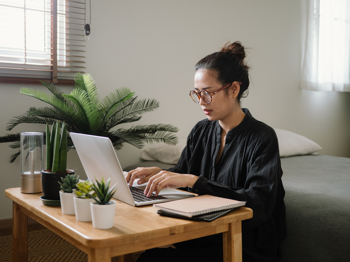 woman searching for a new job online, woman on laptop with glasses