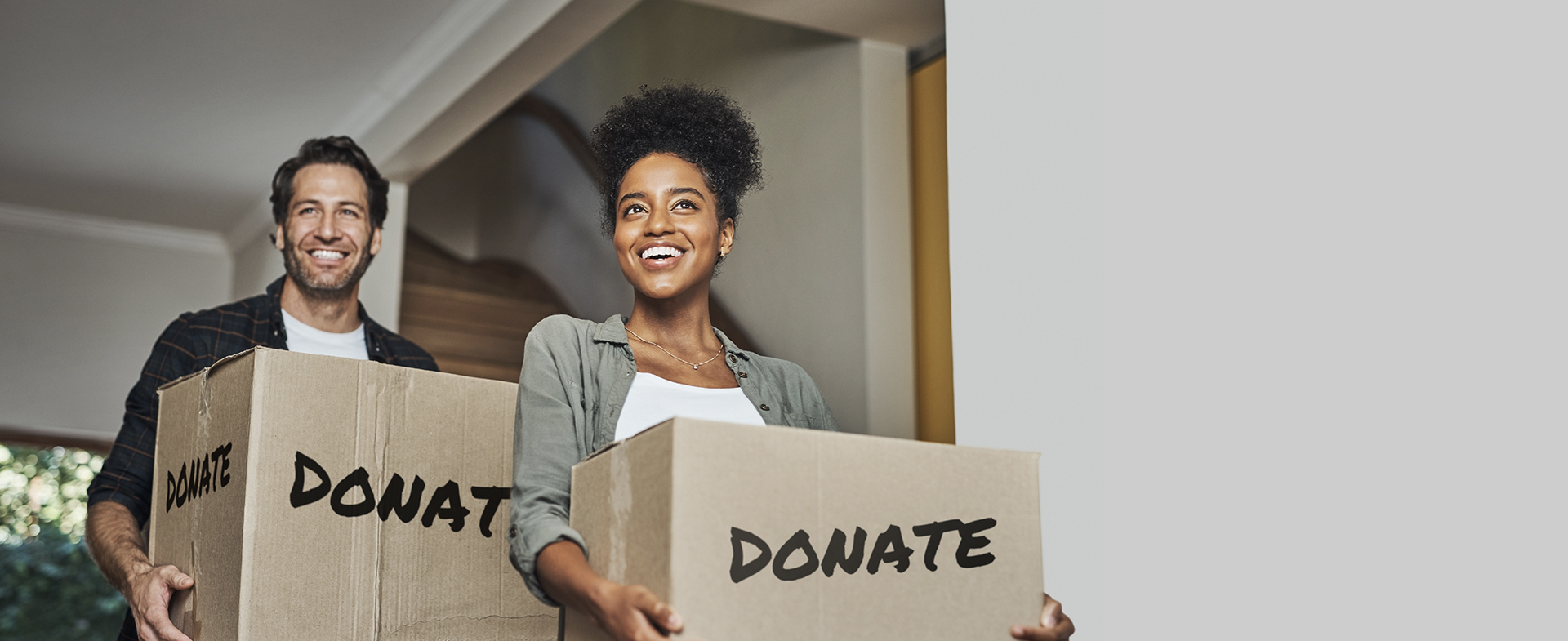 Two people carrying donation boxes
