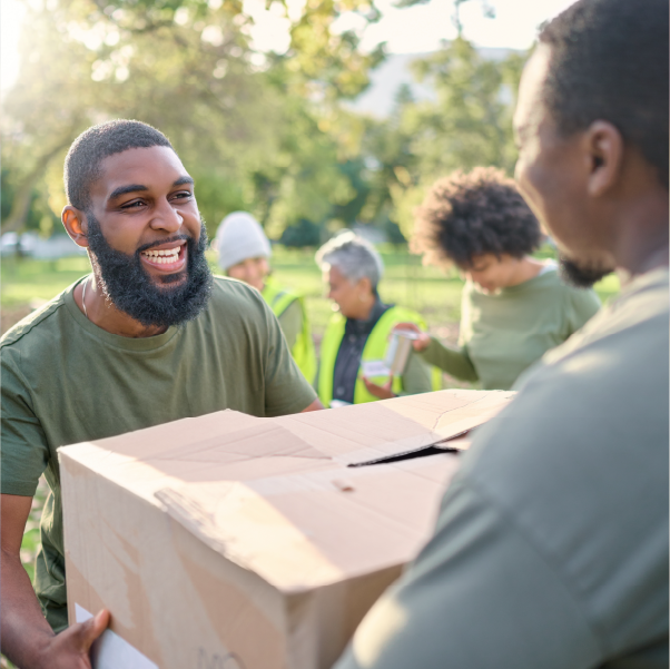 Two men handing a box to eachother