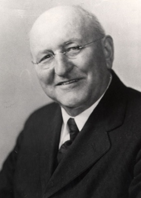 A black and white photo of a man in a suit