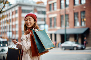A women outside holding shopping bags