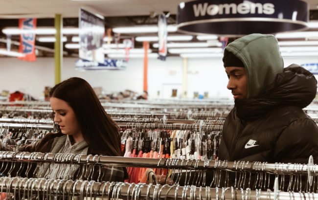 man and woman looking at clothing rack