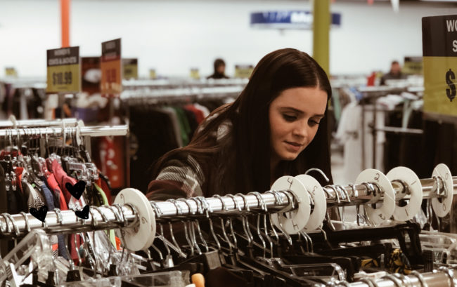 woman looking at clothes on rack